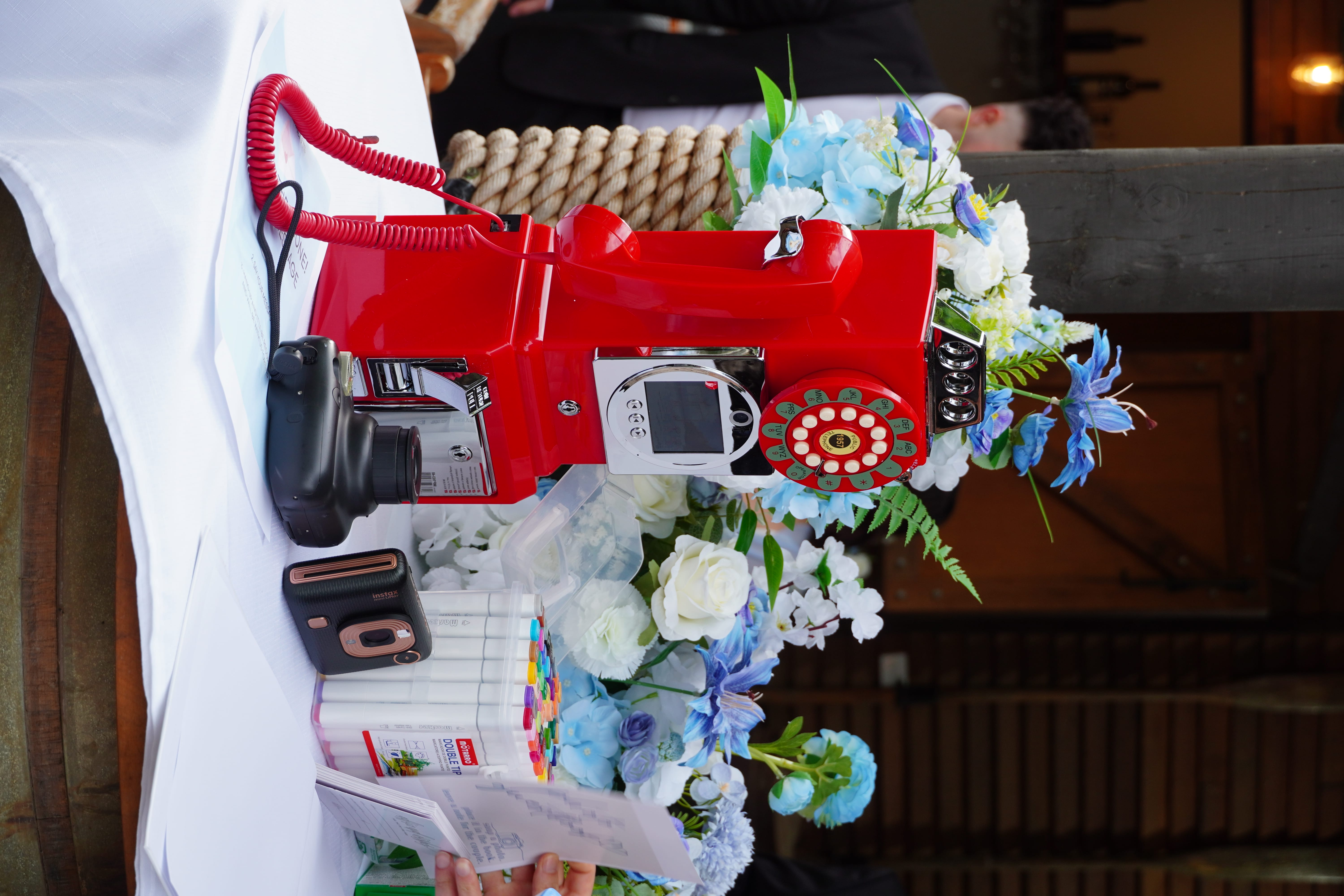 Vintage red phone setup with floral decorations